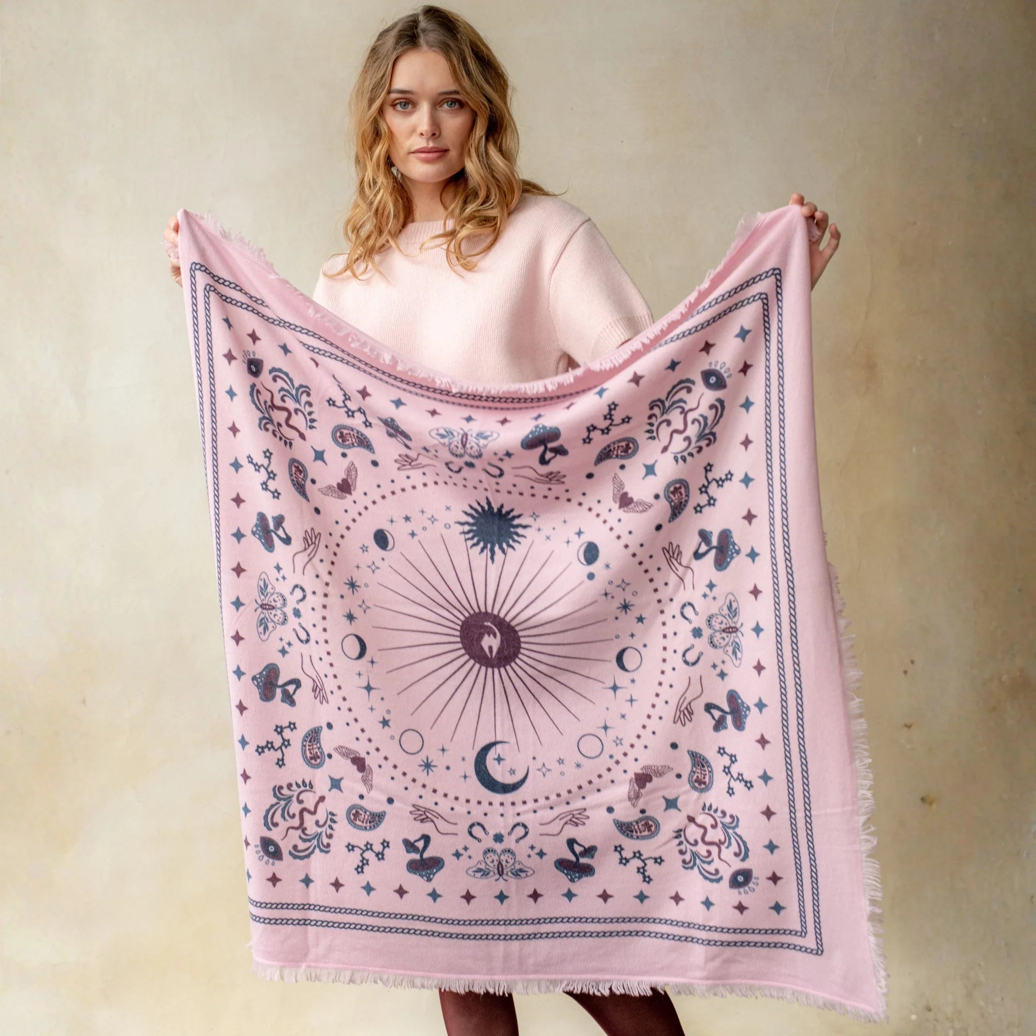 Pink cashmere wrap with celestial moon, star, and butterfly print pattern