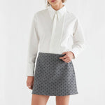 White cotton button-front shirt with pleated bib detail and long sleeves