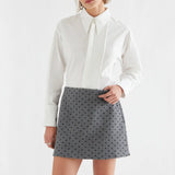 White cotton button-front shirt with pleated bib detail and long sleeves