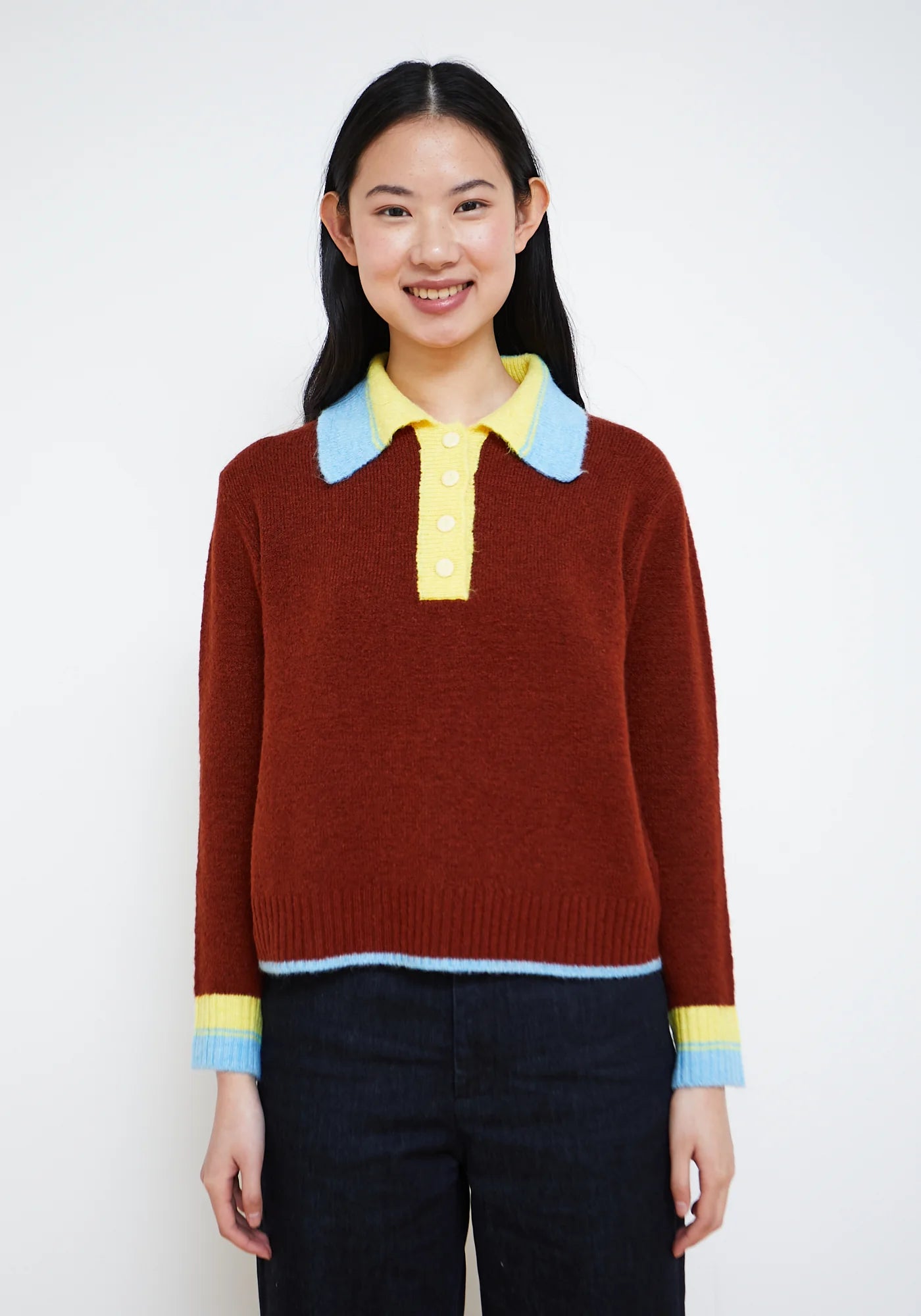 Brown terracotta knit polo sweater with yellow and sky blue collar and cuff details