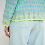 Sky blue fair isle knit sweater with neon green and turquoise pattern, scalloped hem