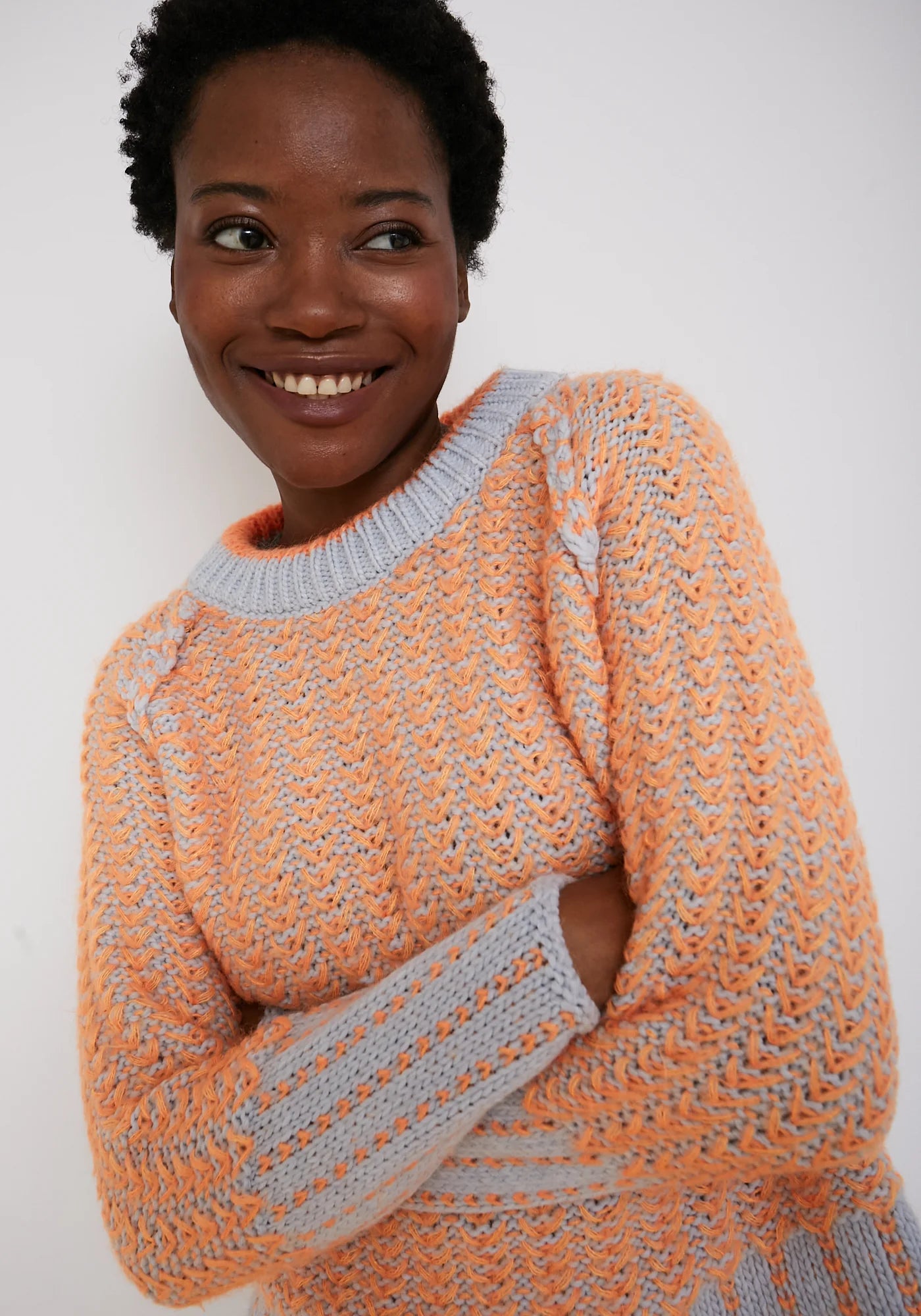 Orange and grey two-tone textured knit crew neck sweater with raglan sleeves