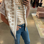 Cream and tan paisley floral knit triangle scarf worn as wrap vest