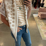 Cream and tan paisley floral knit triangle scarf worn as wrap vest