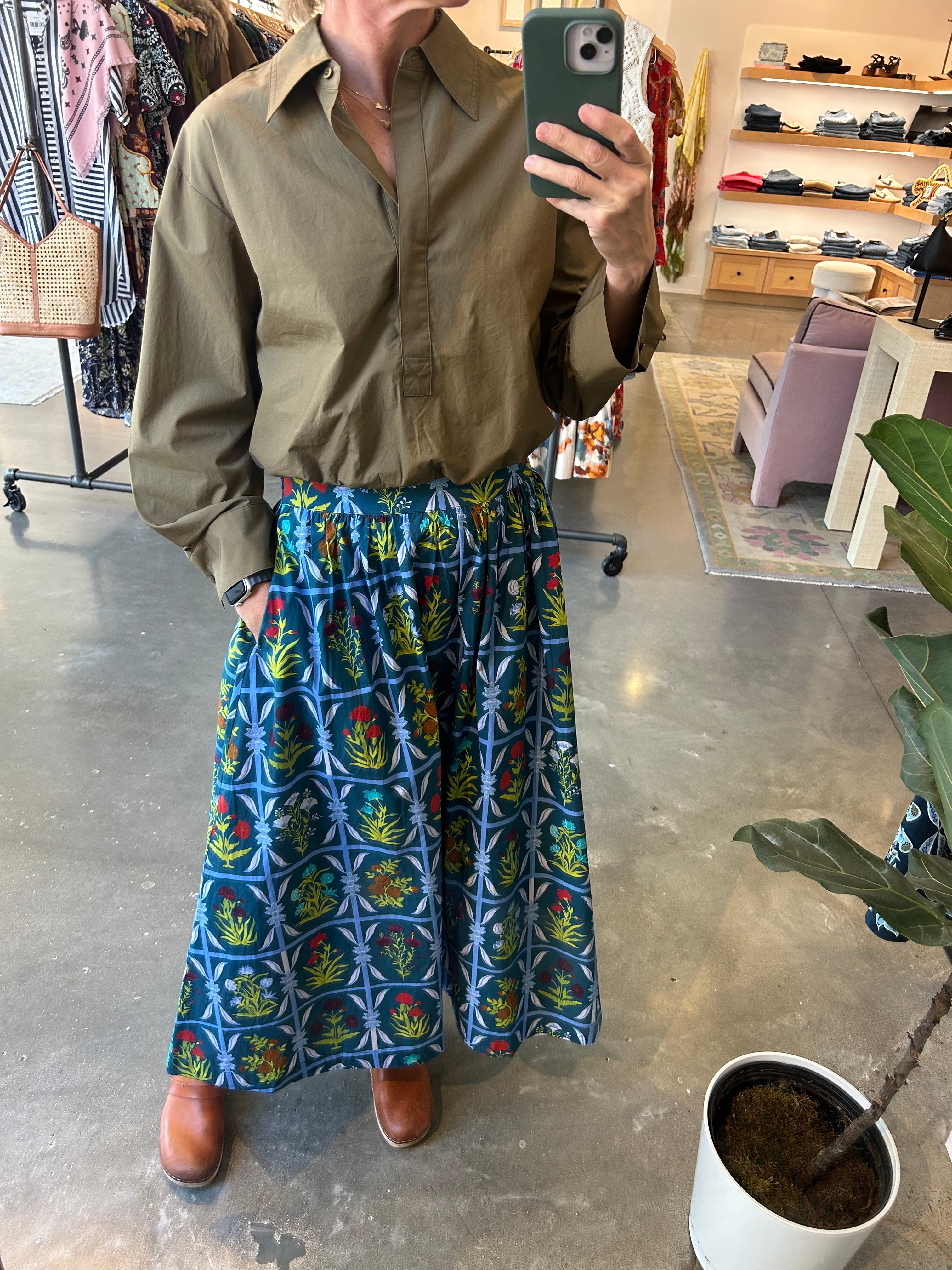 Teal floral grid-print maxi skirt with gathered waist, styled with olive shirt and brown boots.