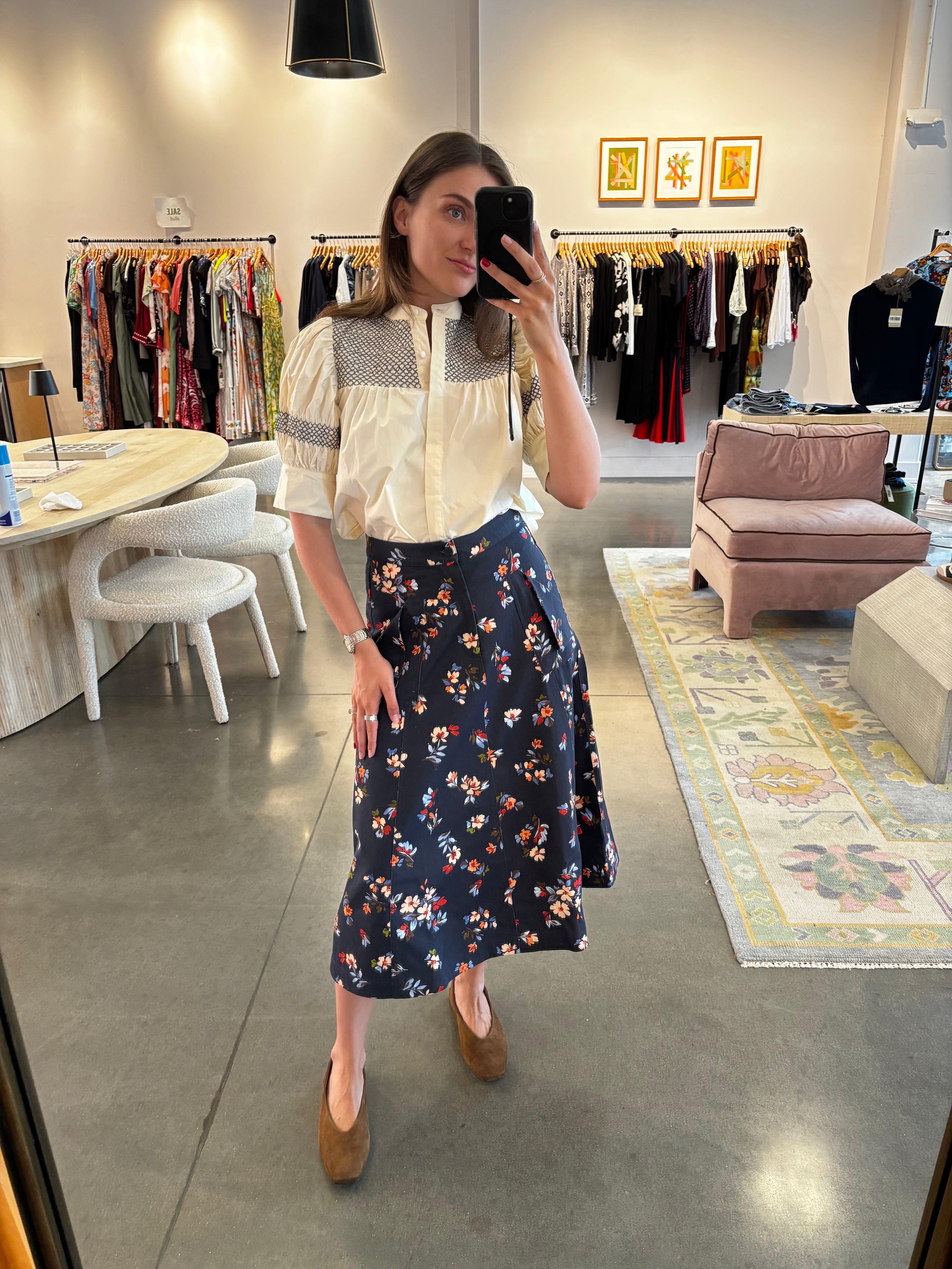 Navy midi skirt with multicolor floral print, A-line silhouette, worn with cream blouse