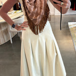 Tan tie-dye pashmina scarf with brown leather fringe trim, styled as neckerchief