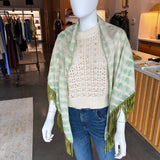 Green and white tie-dye pashmina wrap with green fringe trim on mannequin