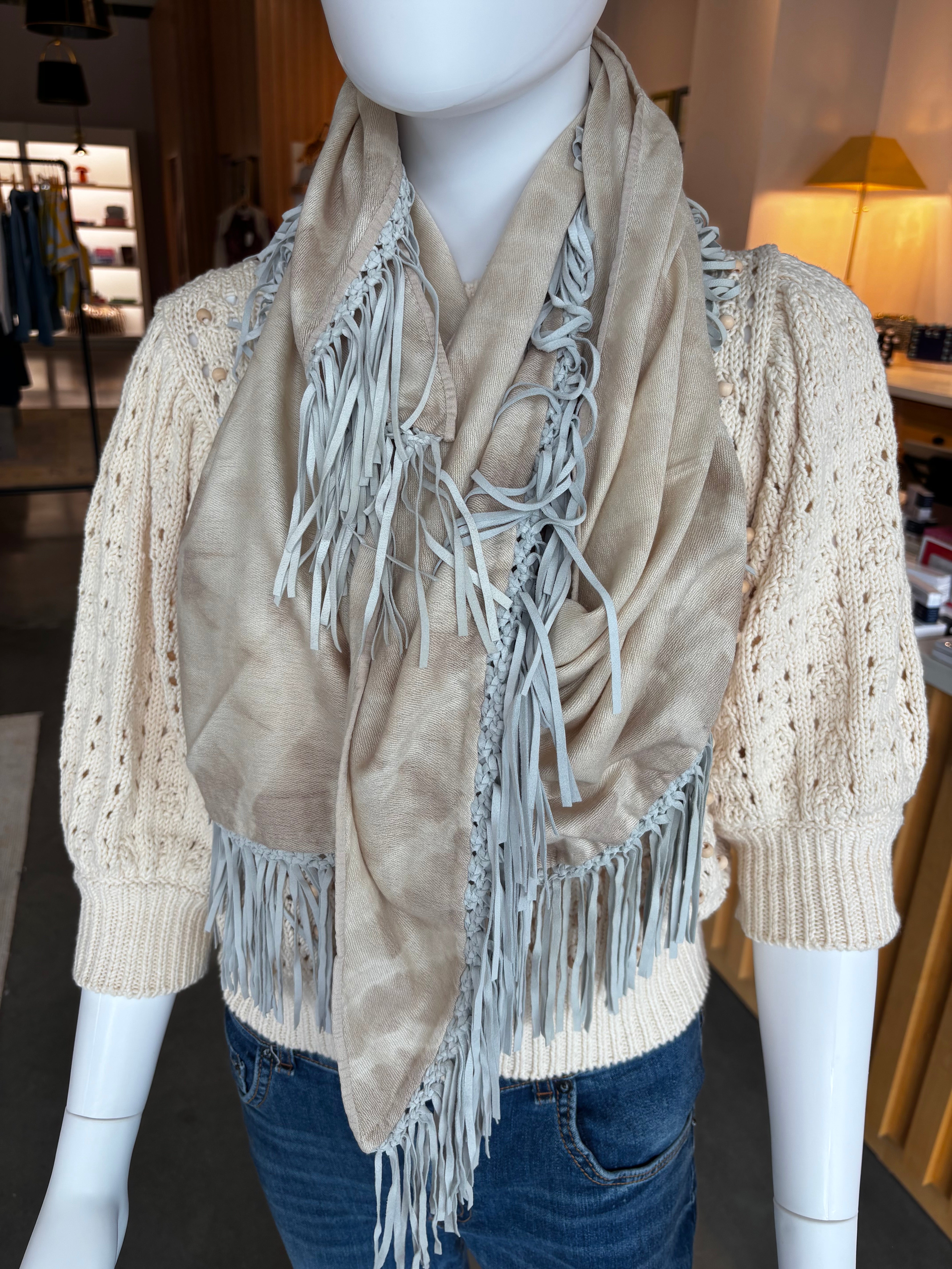 Beige tie dye pashmina scarf with light blue leather fringe trim on mannequin