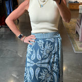 Blue floral wrap midi skirt with wide waistband and belt, paired with cream ribbed top