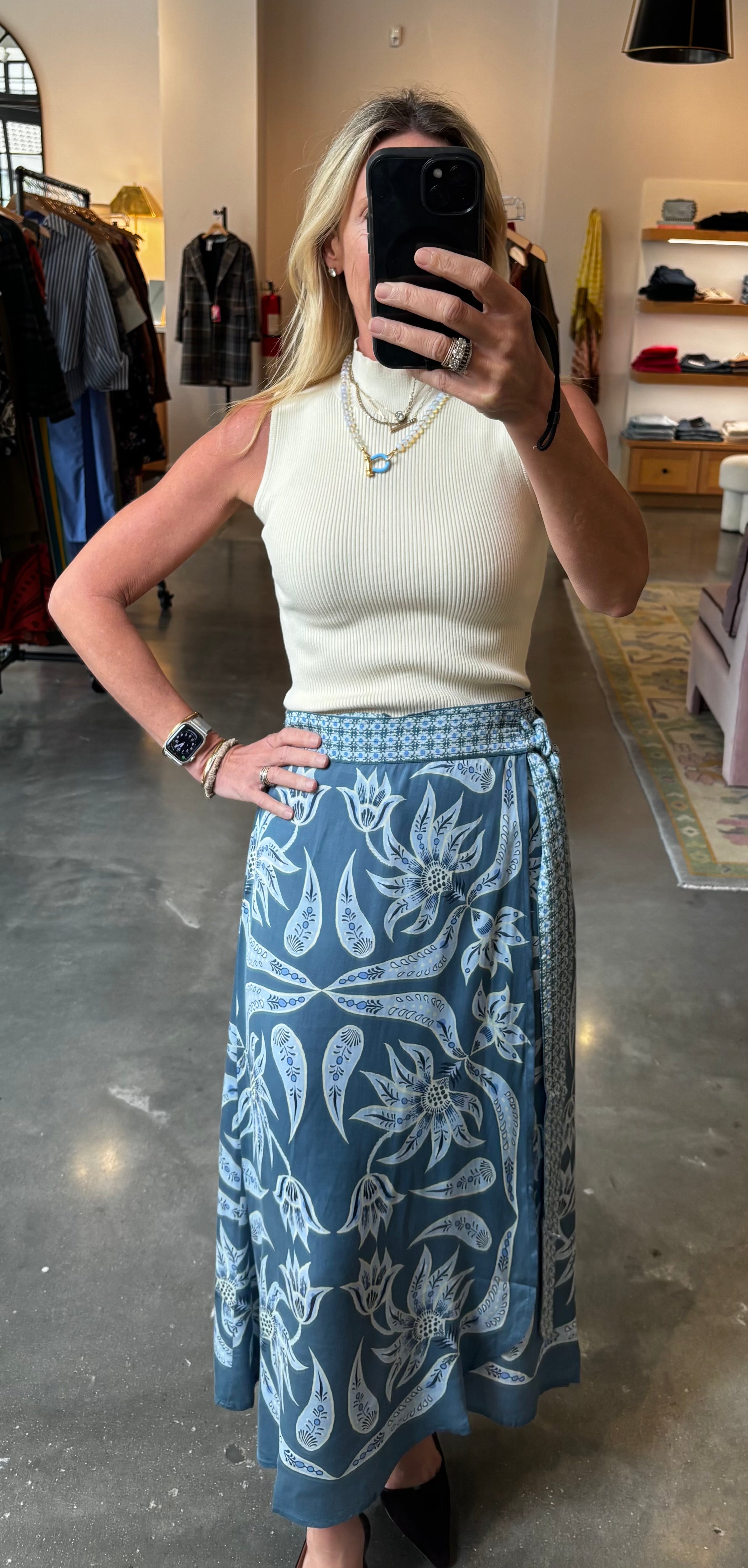 Blue floral wrap midi skirt with wide waistband and belt, paired with cream ribbed top