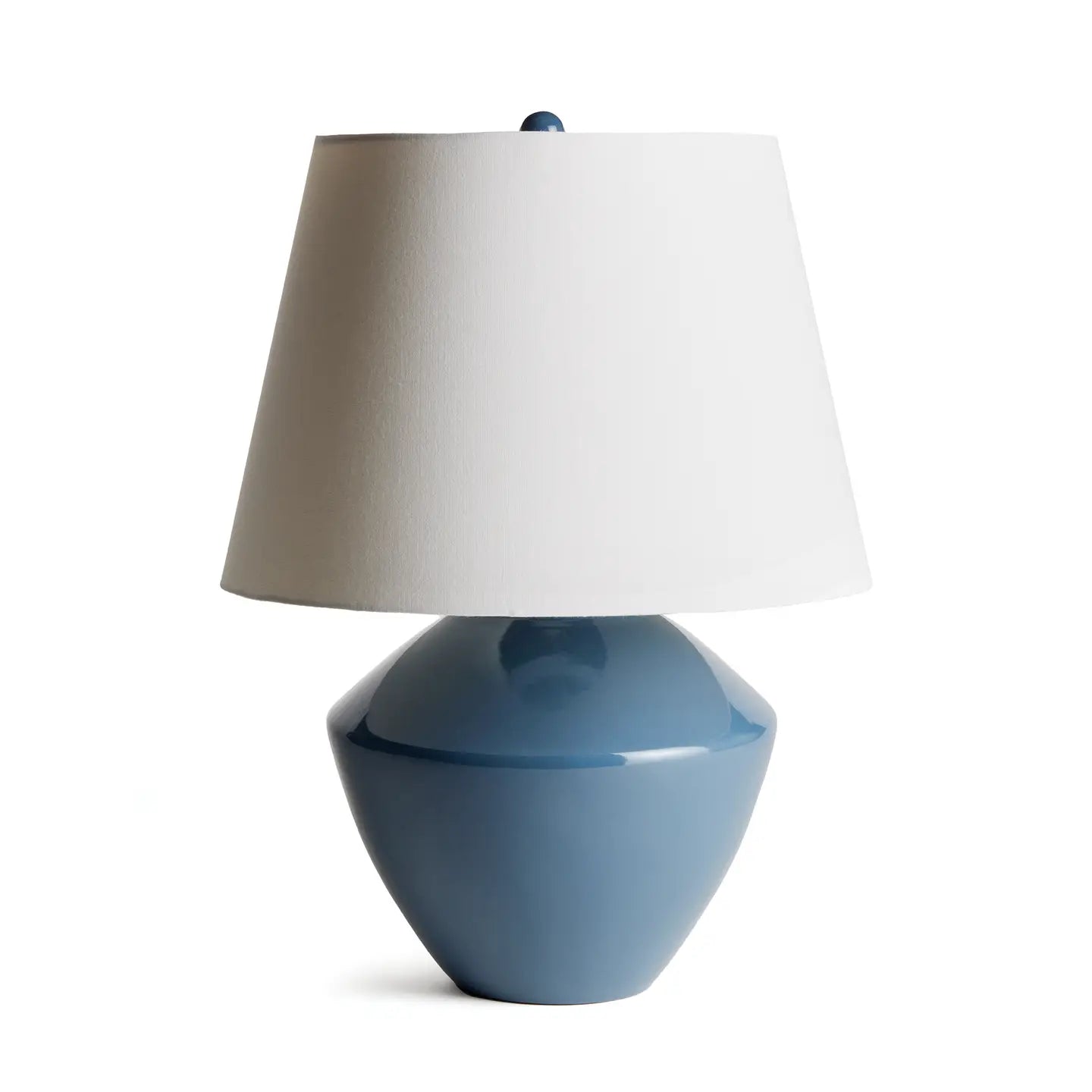 Blue ceramic table lamp with white tapered linen shade and small blue finial