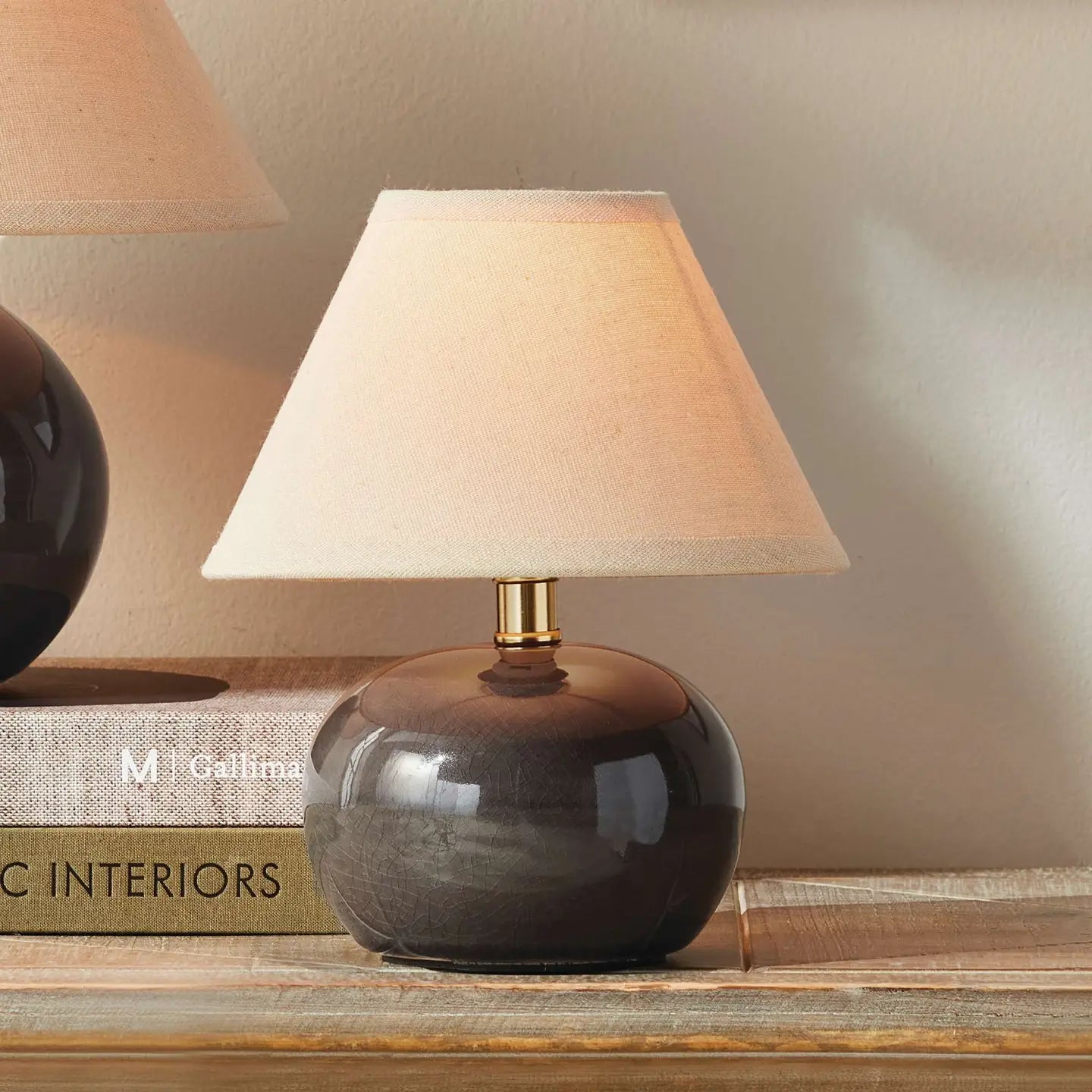 Napa Home Oscar Mini Lamp with round dark ceramic base and beige linen shade