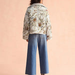 Omika Goldie quilted floral jacket in light blue worn with wide-leg jeans, back view