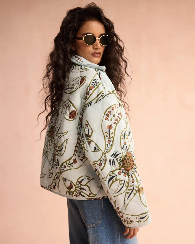 Floral quilted puffer jacket in light blue with botanical print, oversized fit