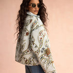 Floral quilted puffer jacket in light blue with botanical print, oversized fit
