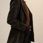 Navy plaid wool blazer with patch pockets, worn open over brown knit top