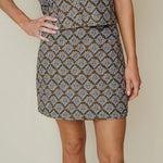 Olive green and blue floral print mini skirt with fitted straight silhouette