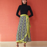 Midi wrap skirt in black floral print with lime green geometric border and tie waist