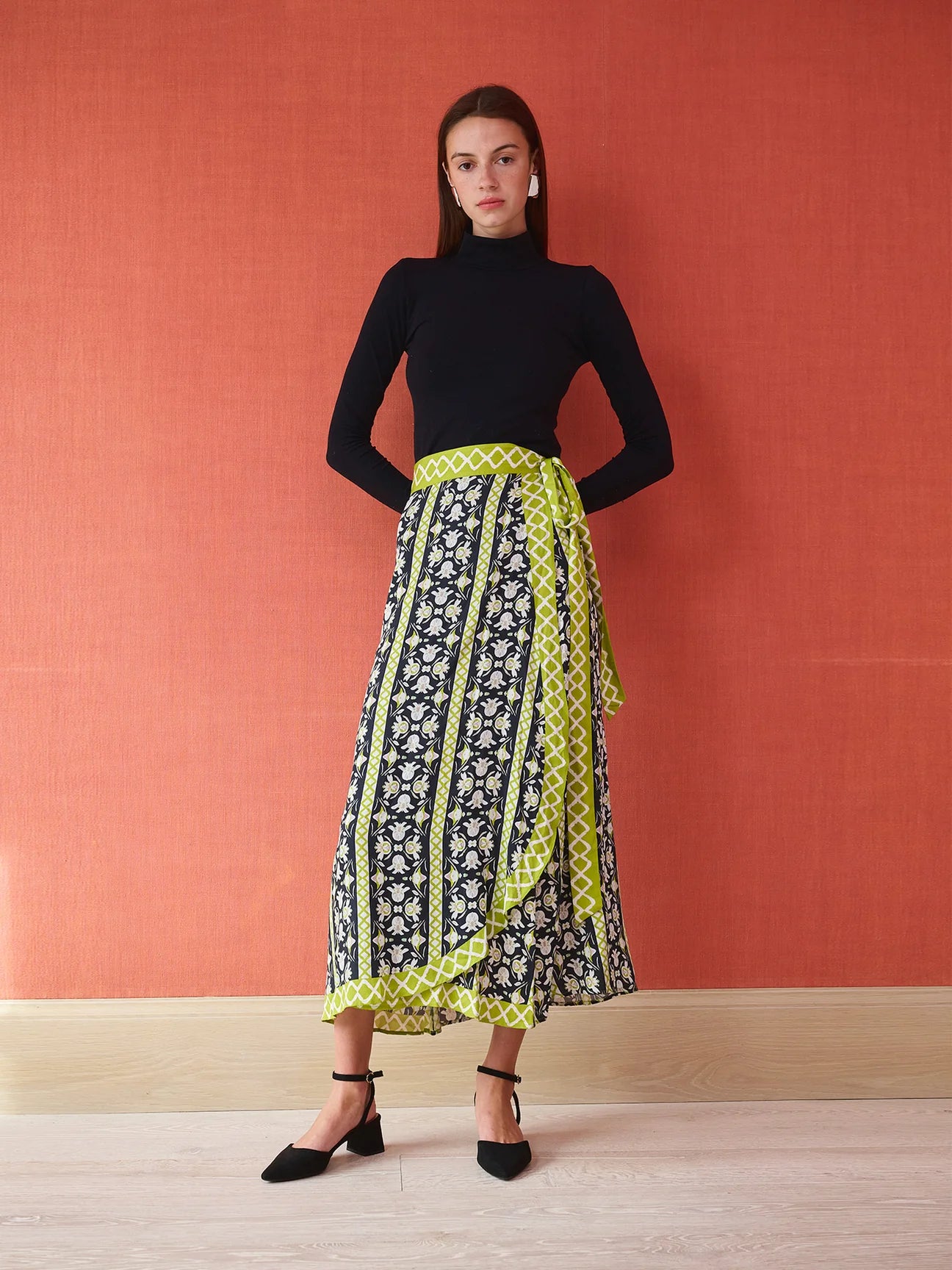 Midi wrap skirt in black floral print with lime green geometric border and tie waist