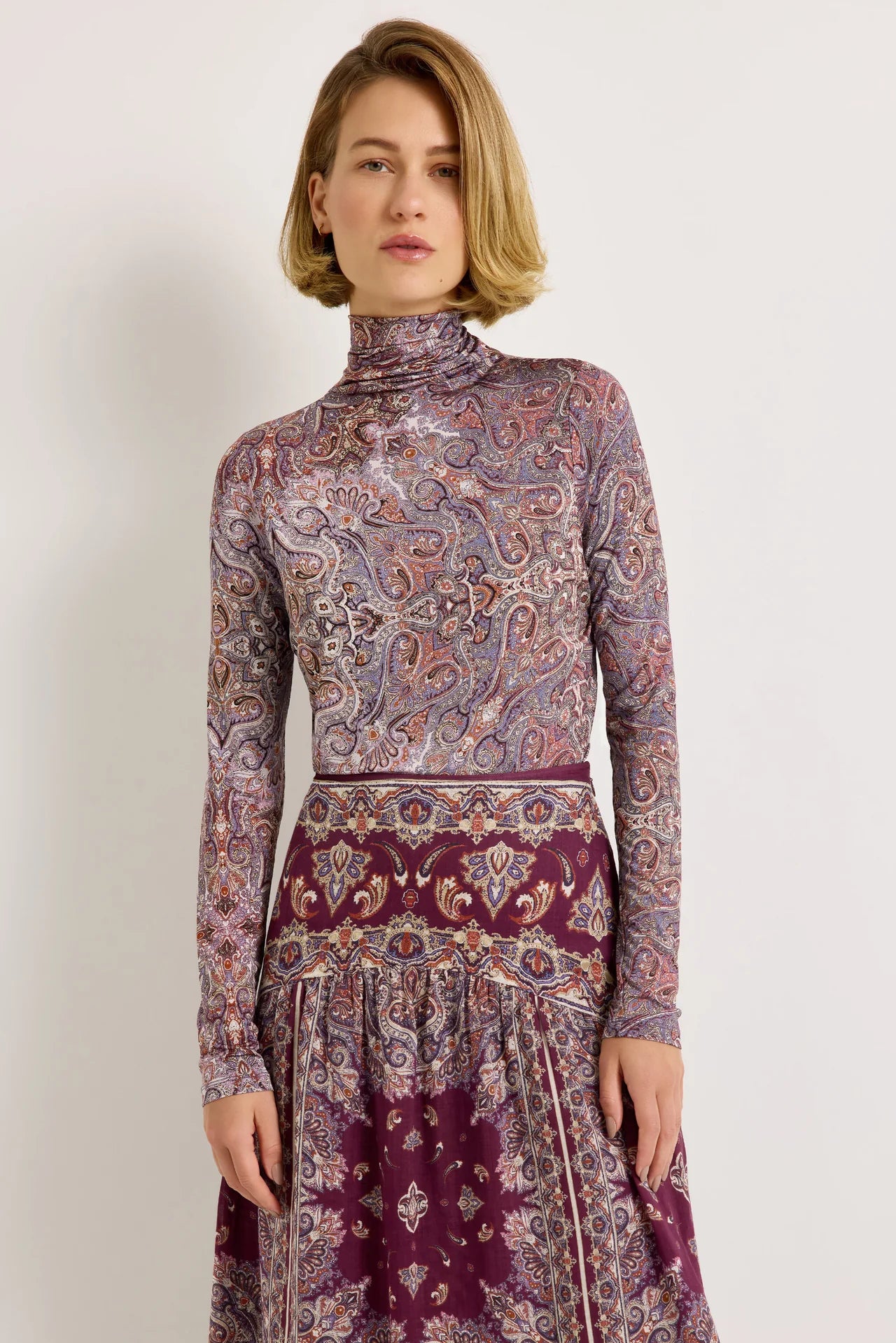 Fitted paisley print turtleneck top in purple and burgundy tones, long sleeves