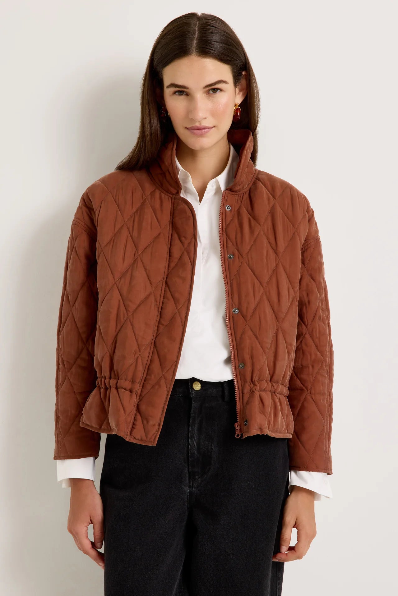 Brown quilted funnel-neck jacket with diamond pattern and cinched drawstring waist