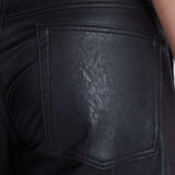 Close-up back pocket detail of black vegan leather barrel pants