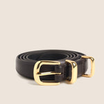 Dark brown skinny leather belt coiled with polished gold buckle and keeper loop