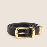 Dark brown skinny leather belt coiled with polished gold buckle and keeper loop