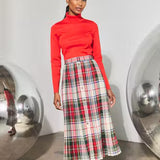 Pleated plaid midi skirt with red turtleneck top and gold front buttons