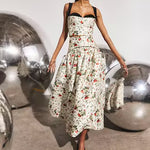 White floral midi skirt with black waistband, full silhouette, worn with matching bustier top