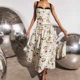 White floral midi skirt with black waistband, full silhouette, worn with matching bustier top