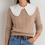 White oversized ruffle Peter Pan collar dickey layered over beige cable-knit sweater