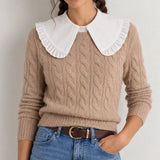 White oversized ruffle Peter Pan collar dickey layered over beige cable-knit sweater