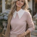 White pointed detachable collar styled over a blush pink sweater on a woman