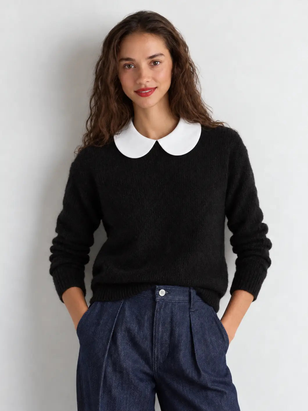 White Peter Pan collar dickey layered over black sweater, front view