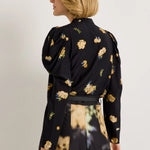 Black floral blouse with yellow blooms, puff shoulders, and long sleeves