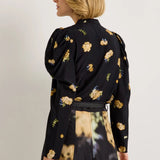 Black floral blouse with yellow blooms, puff shoulders, and long sleeves