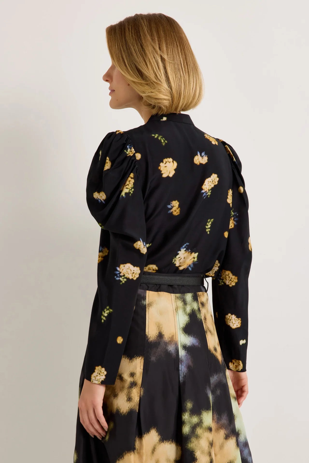 Black floral blouse with yellow blooms, puff shoulders, and long sleeves