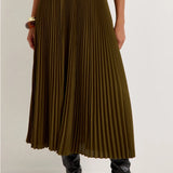 Olive green pleated midi skirt with black elastic waistband, styled with black knee-high boots