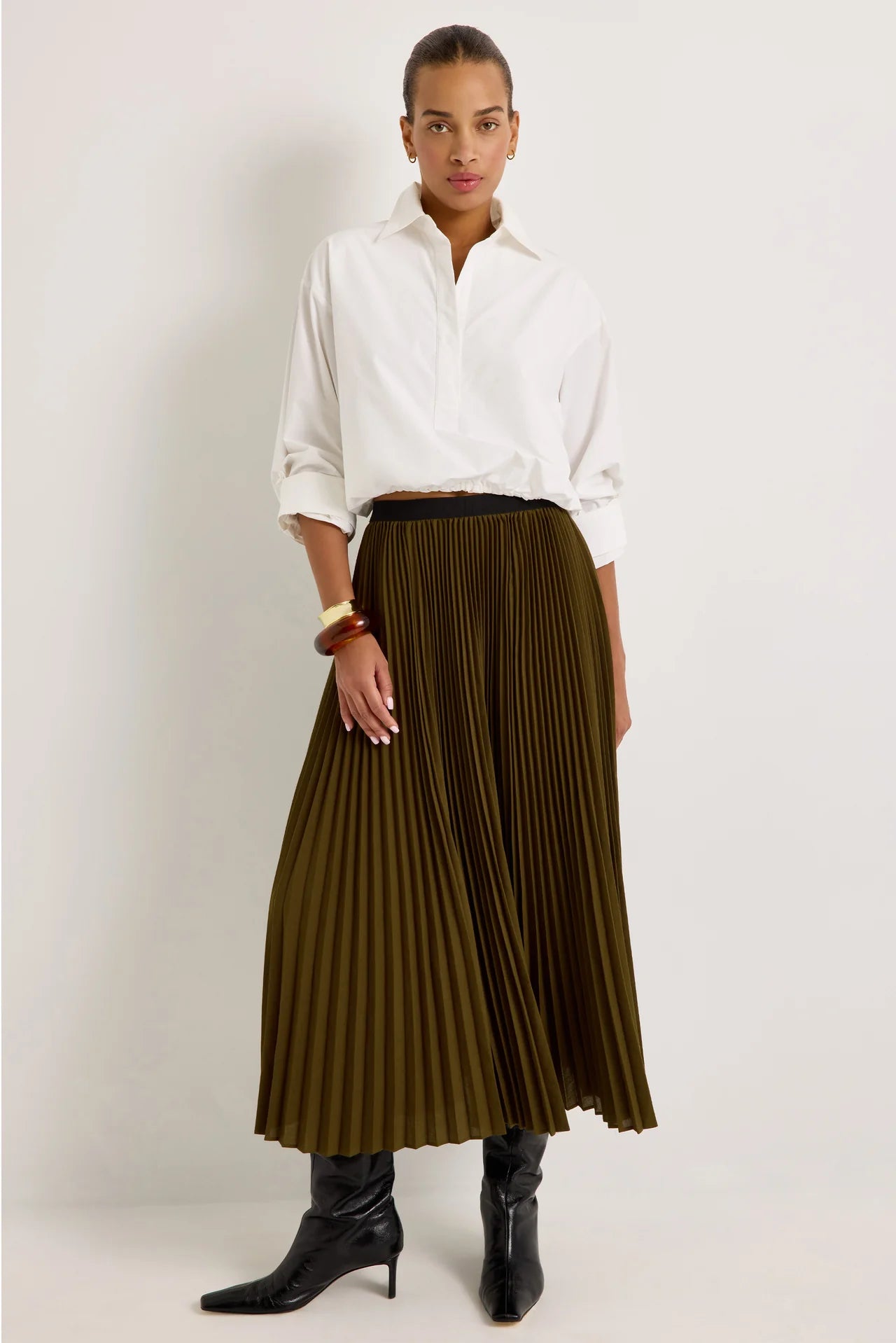 Olive green pleated maxi skirt with black elastic waistband, A-line silhouette