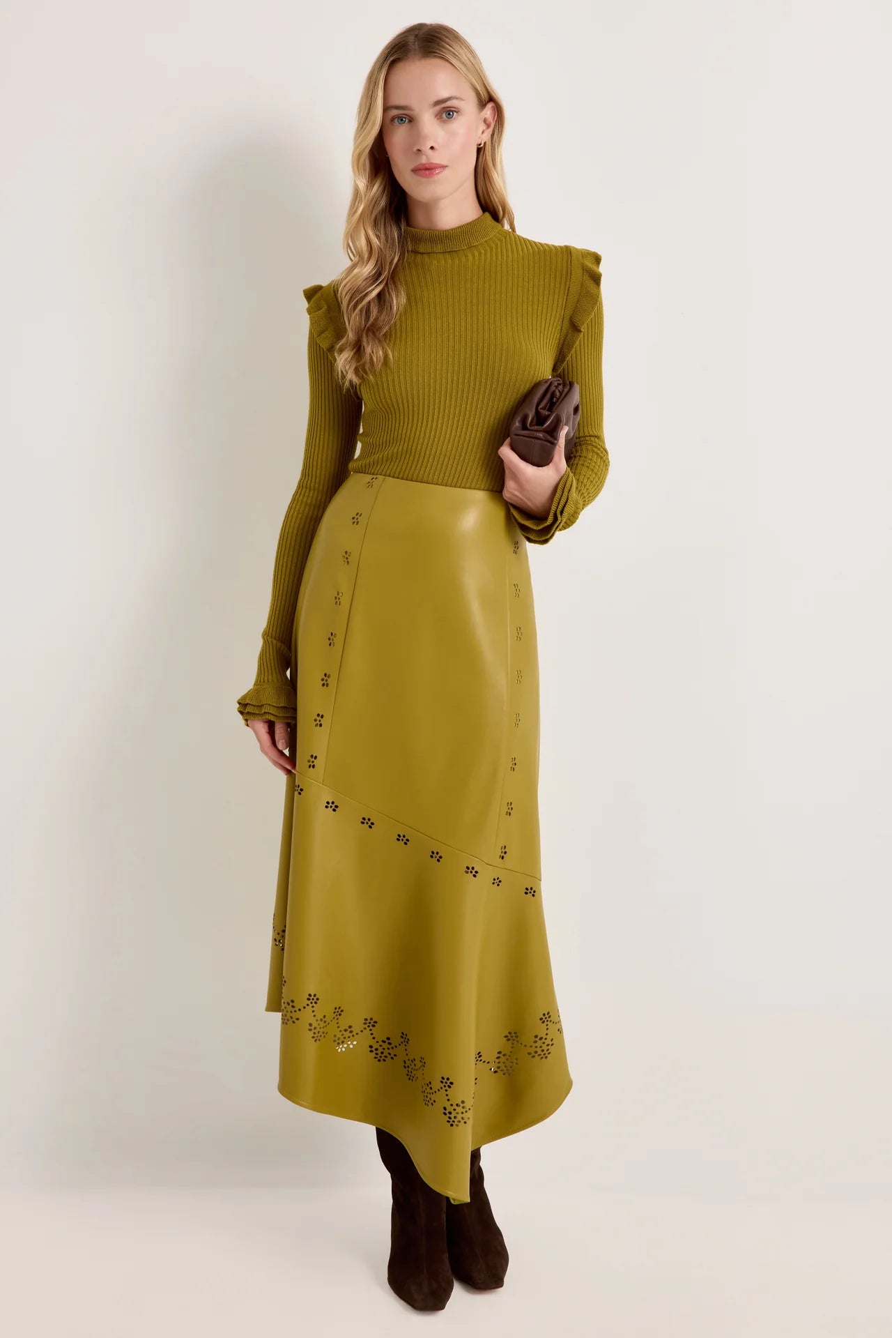 Olive green faux leather midi skirt with laser-cut floral detail and asymmetric hem