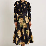 Black midi skirt with abstract yellow floral print, box pleats, and belt loops