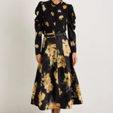 Black midi skirt with abstract yellow floral print, box pleats, and belt loops
