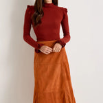 Rust orange suede A-line midi skirt with paneled seams and flared silhouette