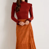 Rust orange suede A-line midi skirt with paneled seams and flared silhouette