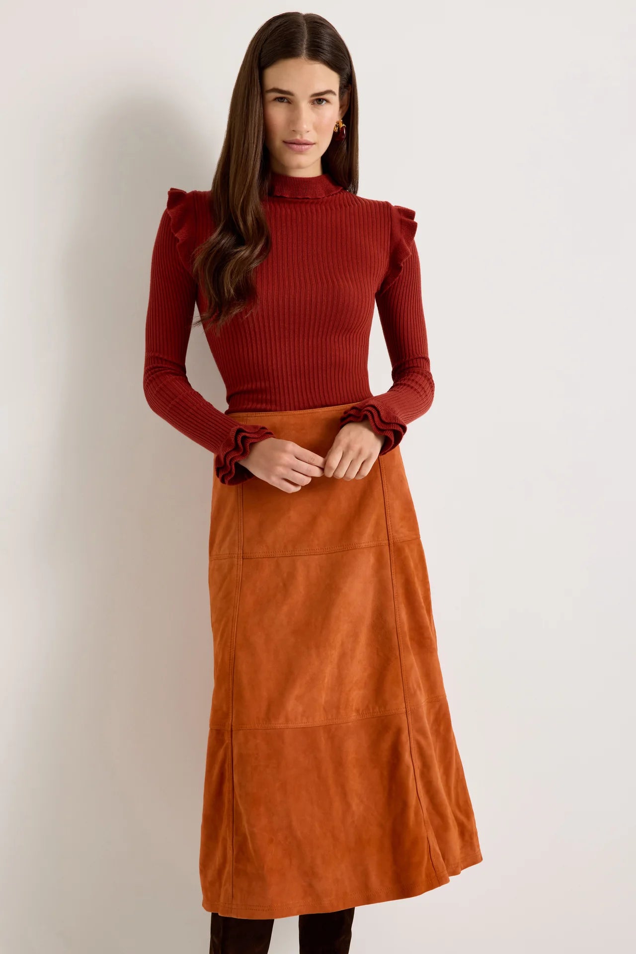 Rust orange suede A-line midi skirt with paneled seams and flared silhouette