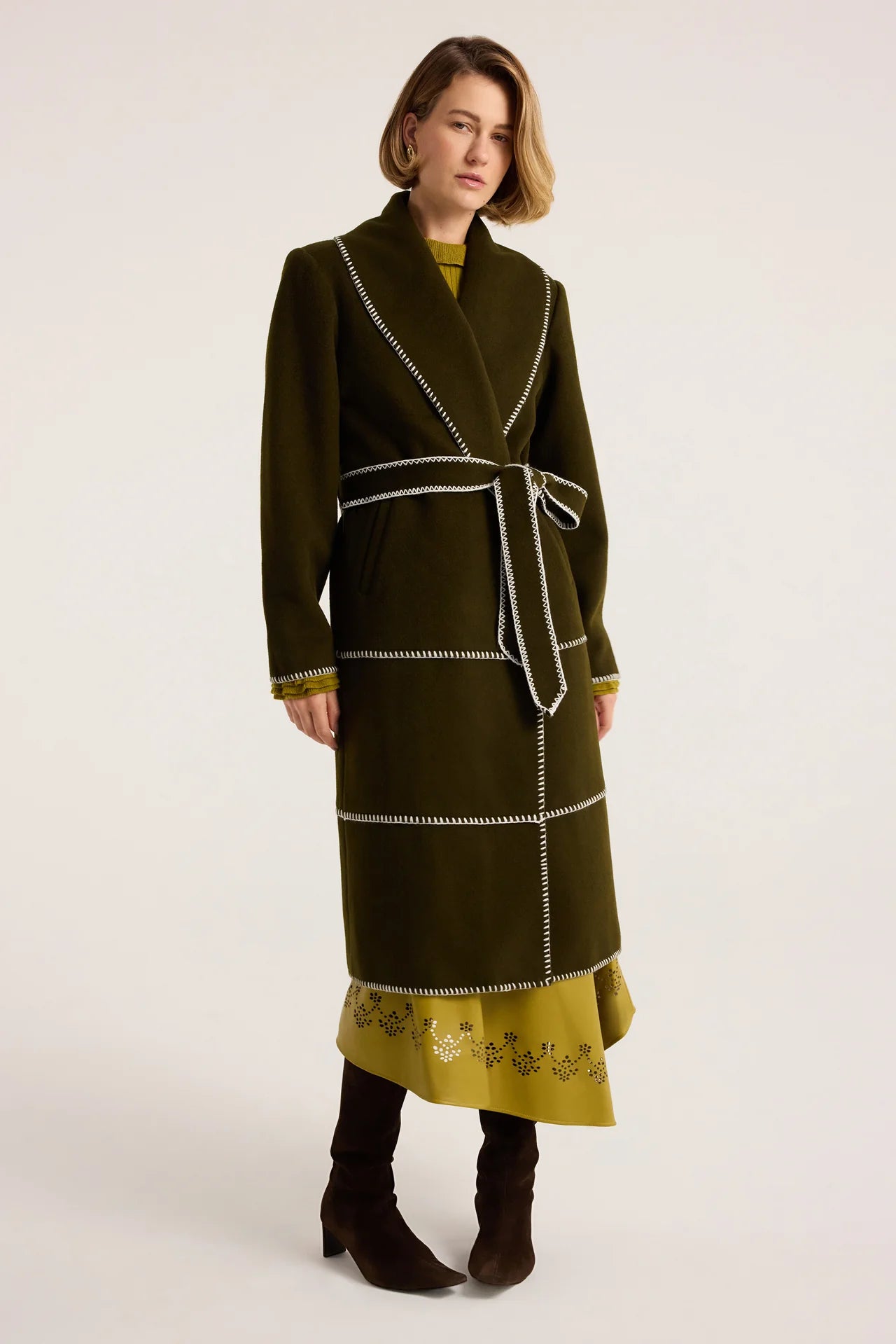 Olive green wool wrap coat with white blanket stitch trim and self-tie belt