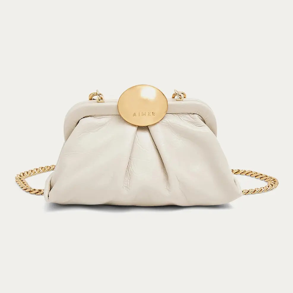Cream leather mini frame crossbody bag with gold circular clasp and chain strap