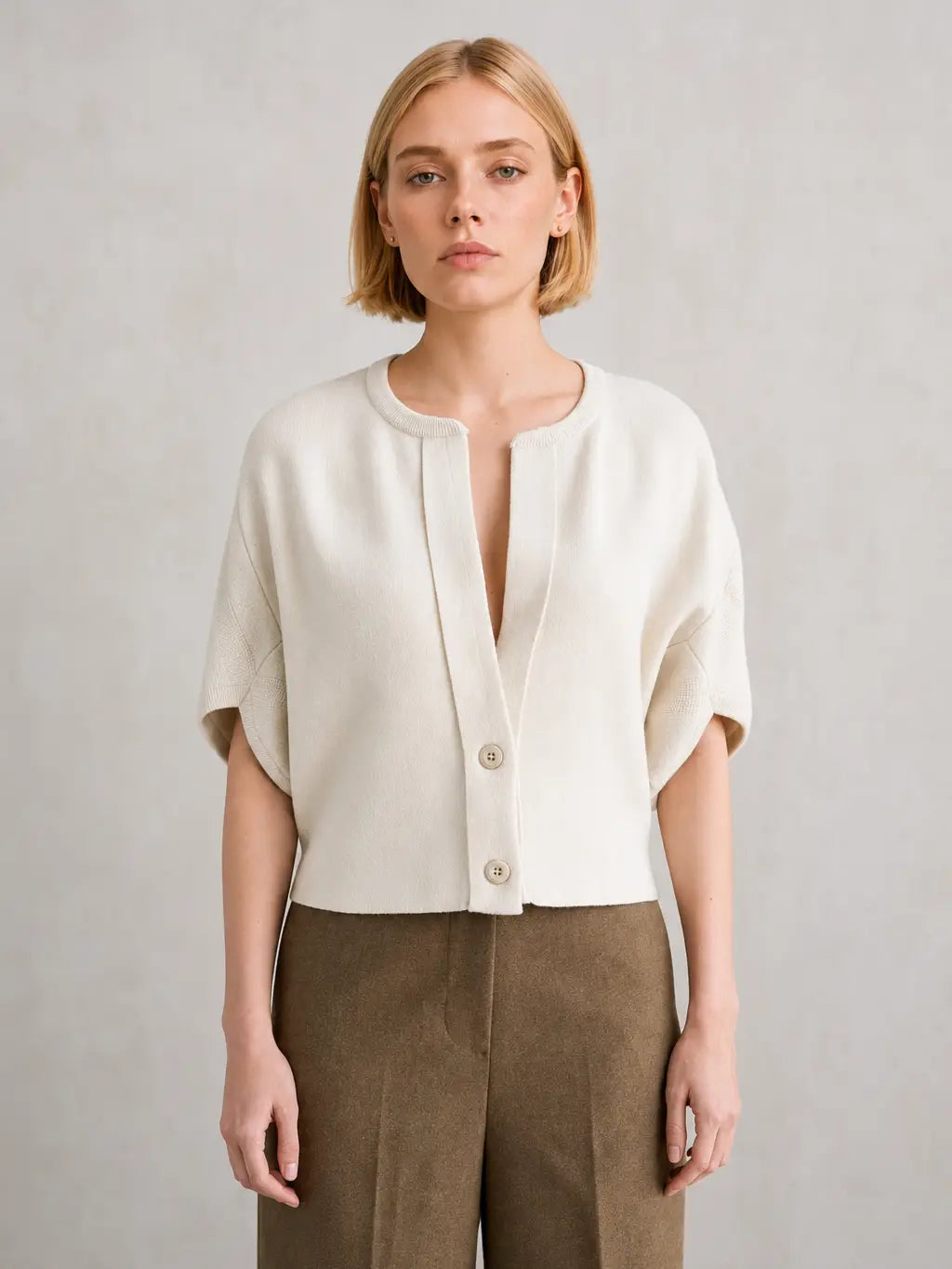 Cream short-sleeve button-front cardigan with drop shoulders and notched neckline